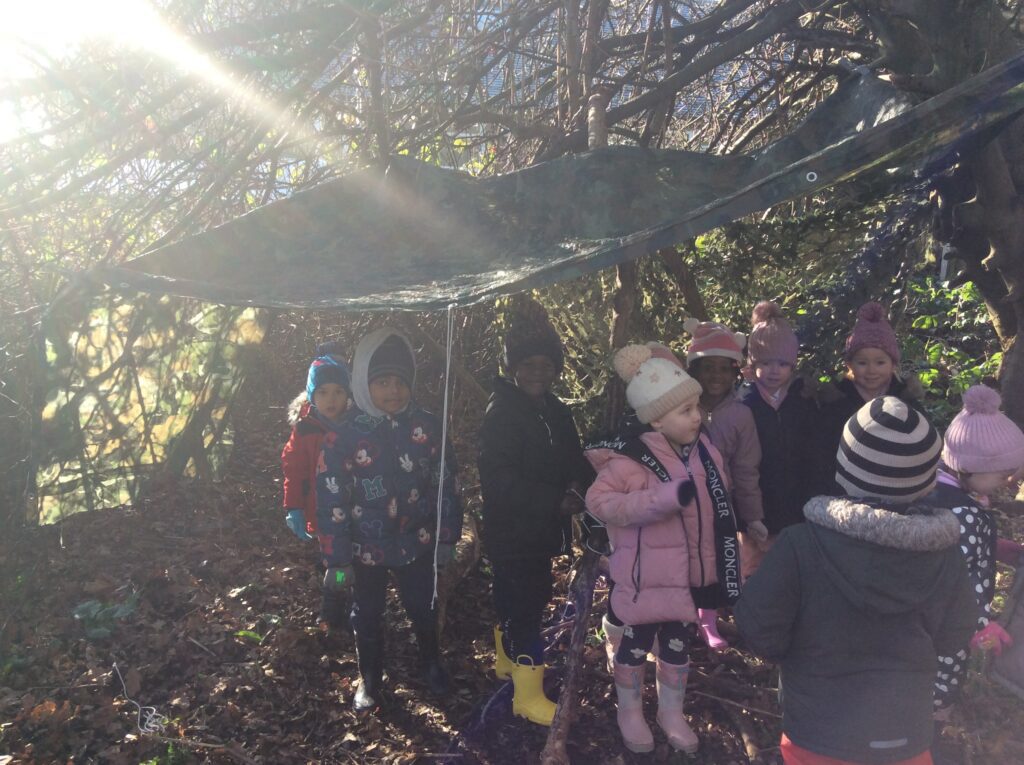 Working Together to Build Shelters at Forest School